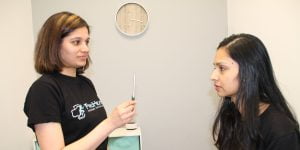 Concussion and Vestibular Rehab in Oshawa Physiotherapist Manu Mrunmayi, a specialist in vestibular rehabilitation, is seen performing an assessment on a patient with concussion. With a pen and eye contact exercises, she carefully evaluates and treats the patient using vestibular physiotherapy techniques. This comprehensive assessment helps in diagnosing and addressing issues related to balance, dizziness, and visual disturbances. Dr. Manu's expertise and attentive approach contribute to the patient's personalized treatment plan, aimed at restoring vestibular function and improving overall well-being. This image showcases the dedication and skill of the physiotherapist in providing effective care for individuals with concussion and vestibular challenges.